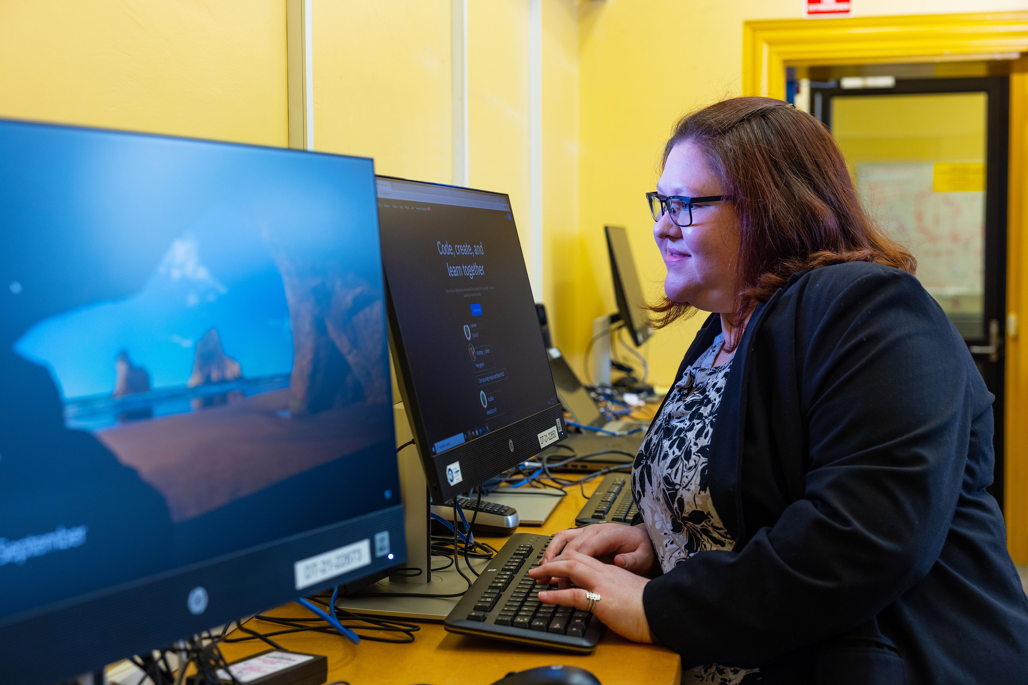 Samantha working at a computer as an IT specialist